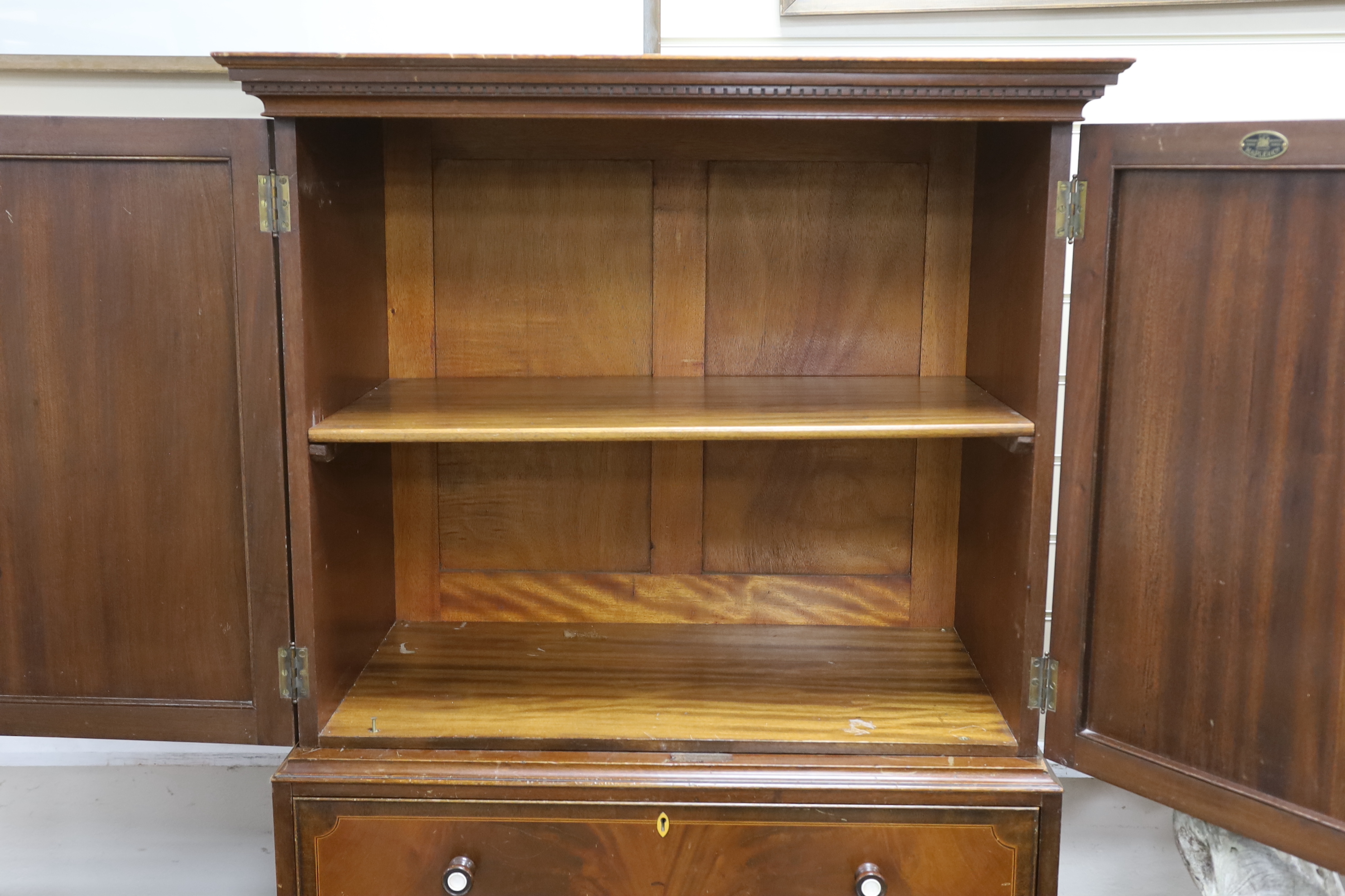 An early 20th century Maple & Co. mahogany narrow press cupboard, width 80cm, depth 45cm, height 168cm